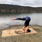 Woman doing a headstand on the Fairy Night ZenMotion cork yoga mat