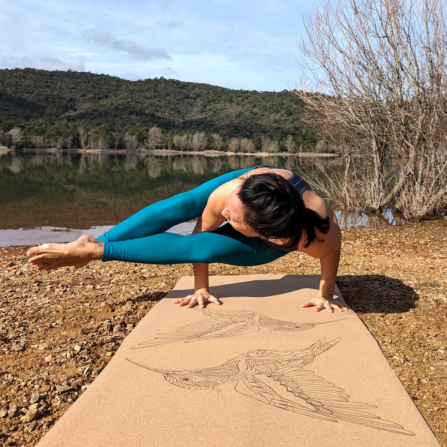 Woman doing the side crow yoga pose on the Flying Jewels ZenMotion cork yoga mat