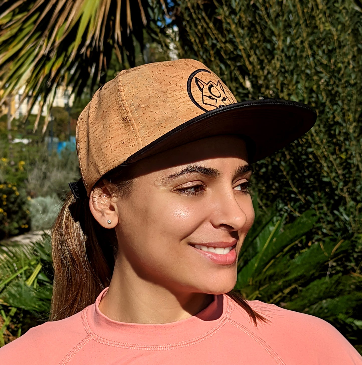 A woman wearing a natural color ZenMotion cork hat.