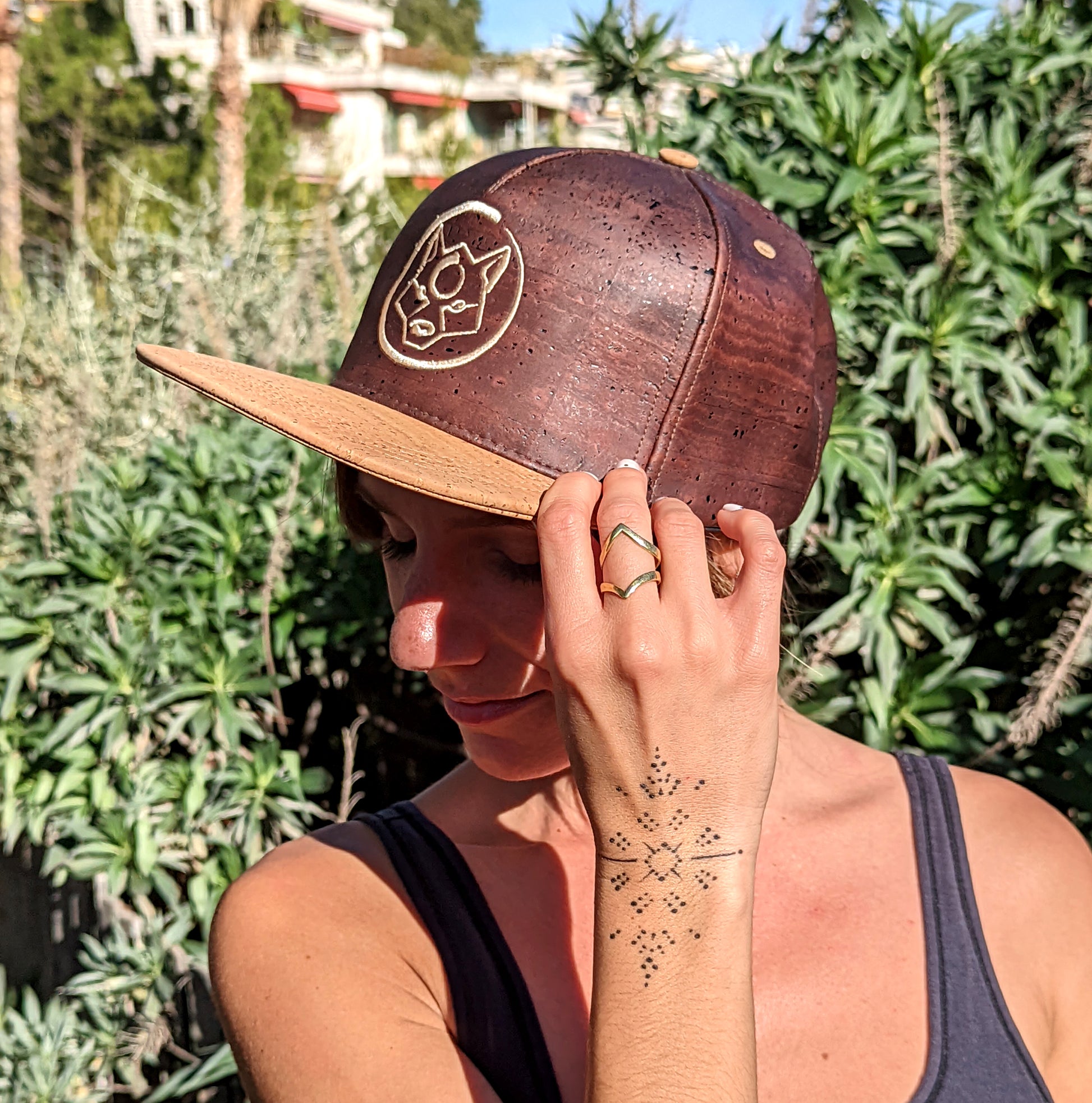 A woman wearing a brown color ZenMotion cork hat.