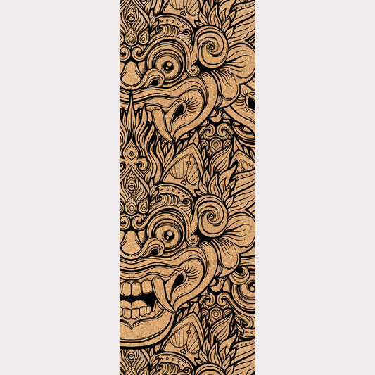 Picture of a cork yoga mat featuring a Barong representation engraved on it.