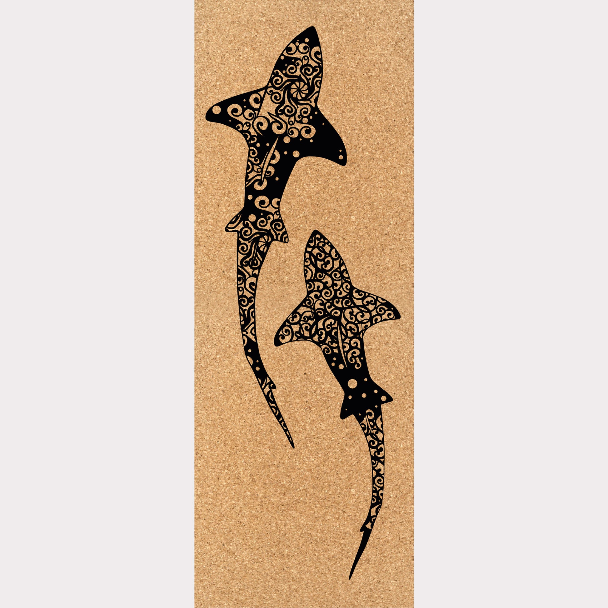 Picture of a cork yoga mat featuring an engraving of two mandala-stylized sharks.