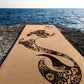 Close-up of the Sea Fairy ZenMotion cork yoga mat placed against a tranquil sea background.